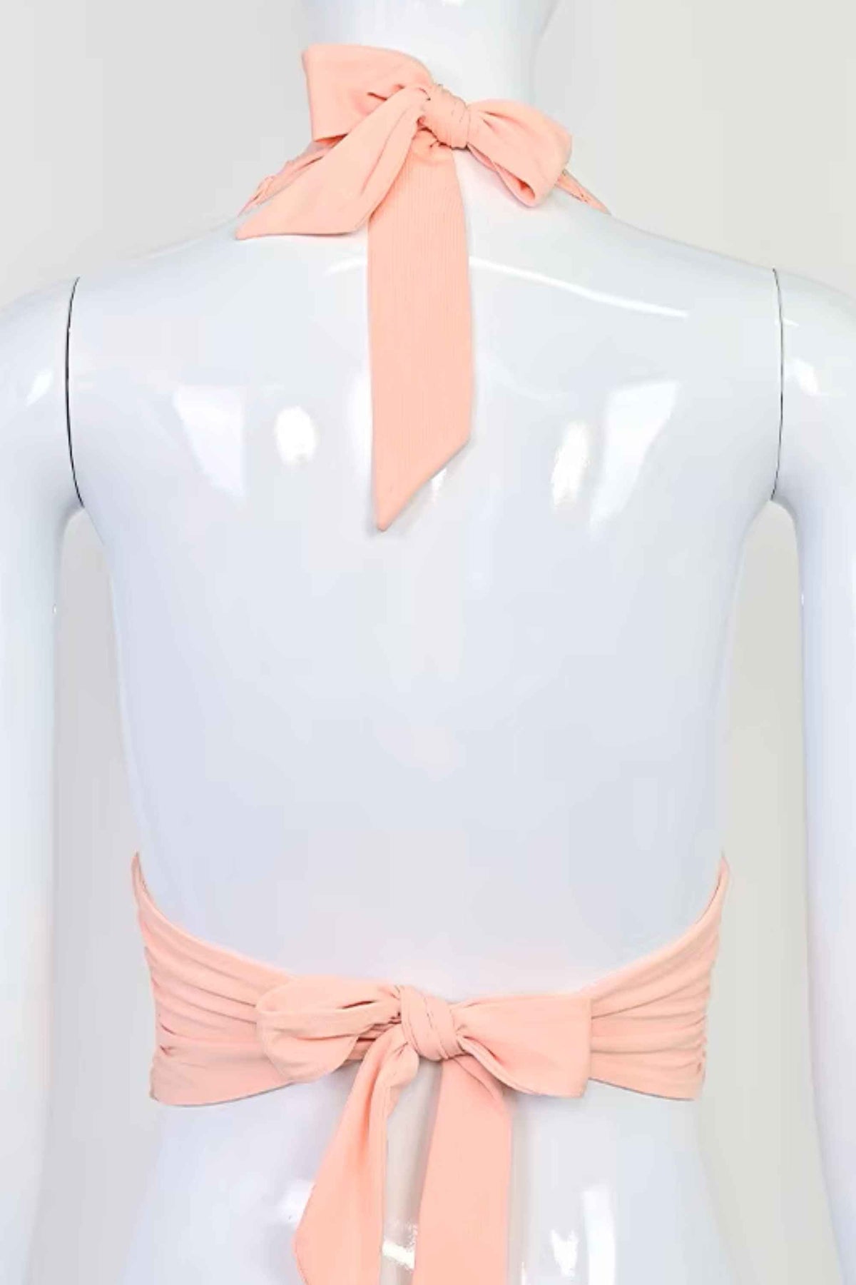 Woman wearing a figure flattering Aby Halter Top - Pink Peach Fuzz BODYCON COLLECTION Pty Ltd