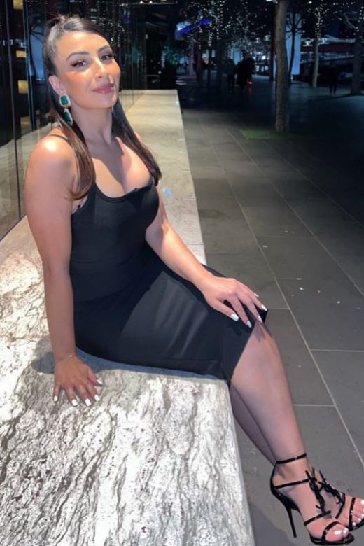 Woman wearing a figure flattering Amber Bandage Dress - Classic Black Bodycon Collection