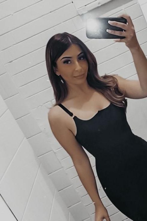 Woman wearing a figure flattering Amber Bandage Dress - Classic Black Bodycon Collection