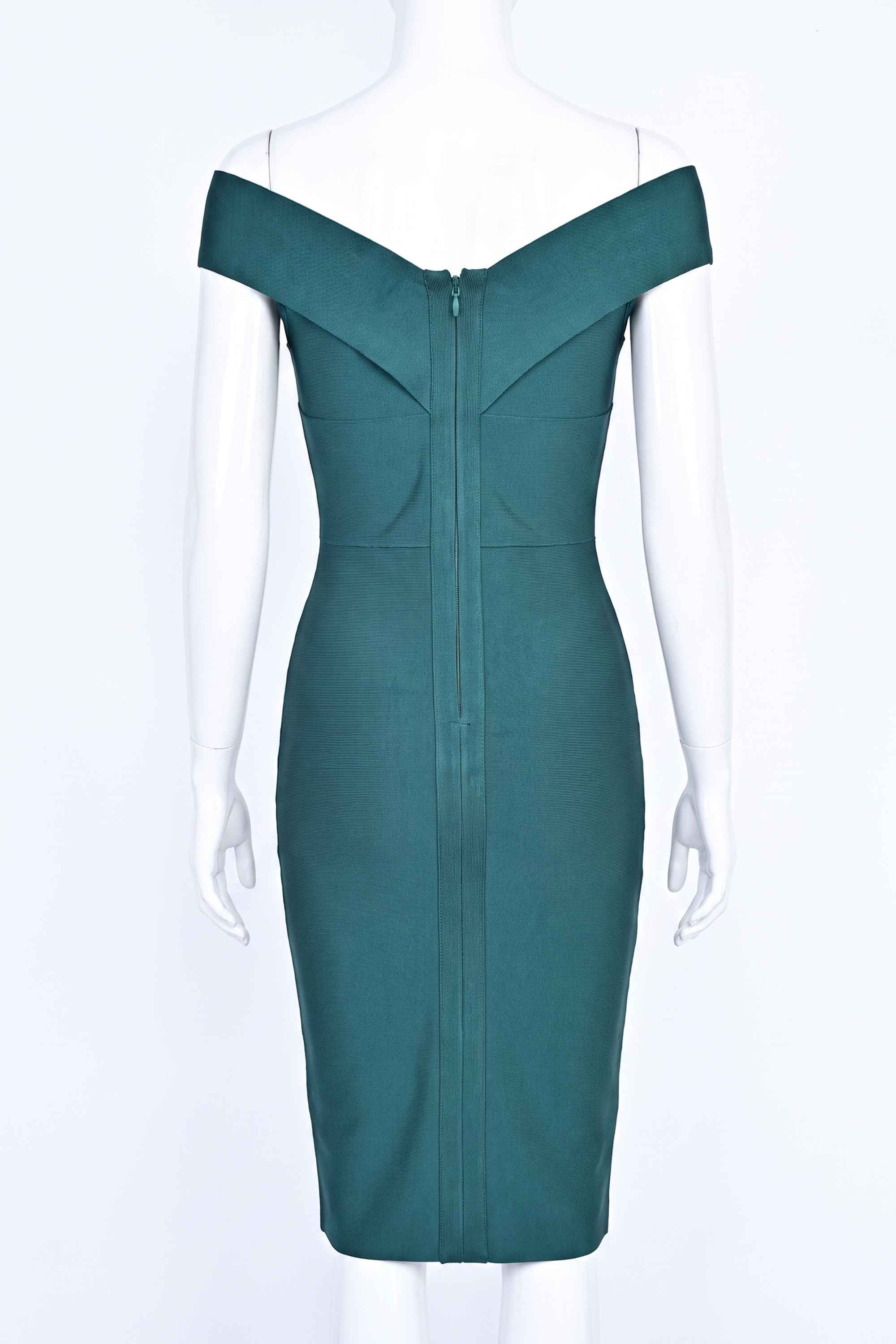 Woman wearing a figure flattering Ash Bandage Dress - Emerald Green Bodycon Collection