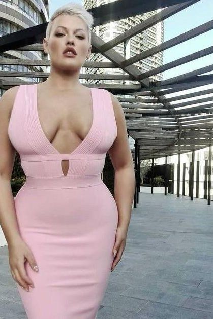 Woman wearing a figure flattering Bay Bandage Dress - Ballet Pink Bodycon Collection