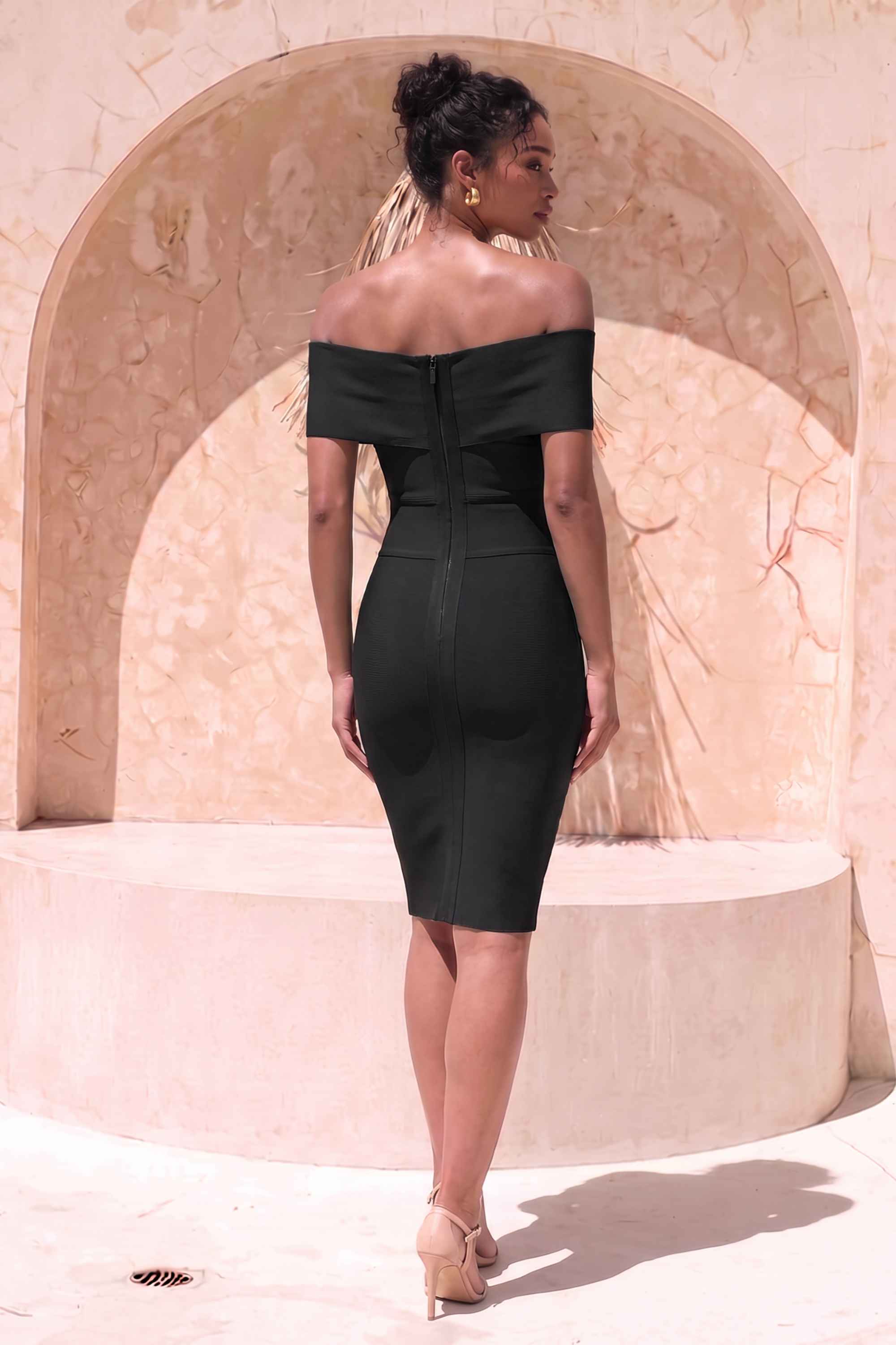 Woman wearing a figure flattering Bea Bandage Dress - Classic Black Bodycon Collection
