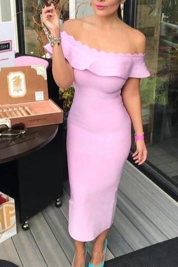 Woman wearing a figure flattering Billie Bandage Midi Dress - Dusty Pink Bodycon Collection