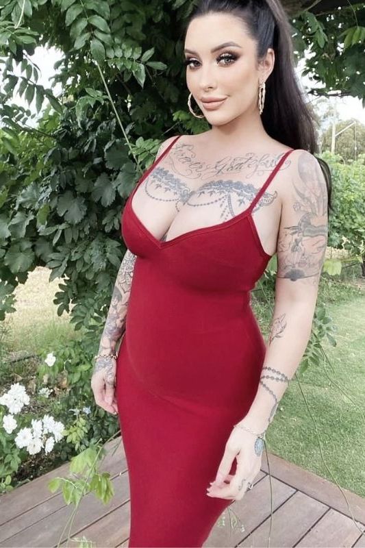 Woman wearing a figure flattering Blanche Bandage Midi Dress - Classic Black BODYCON COLLECTION