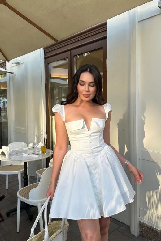 Woman wearing a figure flattering Cara Bodycon Mini Dress - Pearl White BODYCON COLLECTION