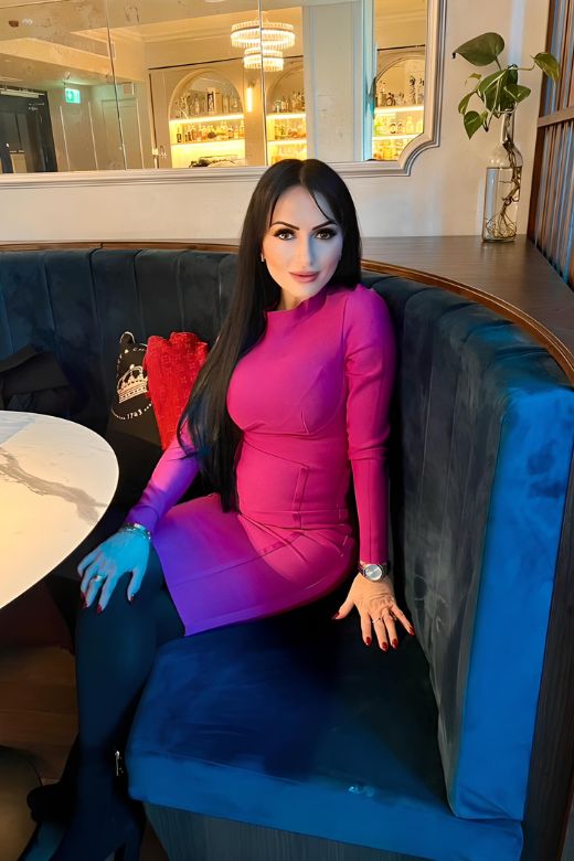 Woman wearing a figure flattering Dee Long Sleeve Bandage Dress - Classic Black BODYCON COLLECTION