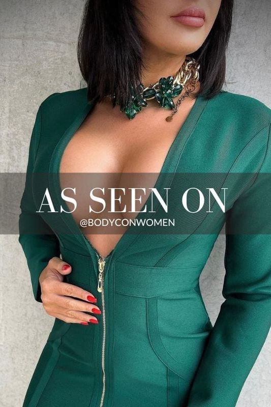 Woman wearing a figure flattering Eva Long Sleeve Bandage Mini Dress - Emerald Green BODYCON COLLECTION