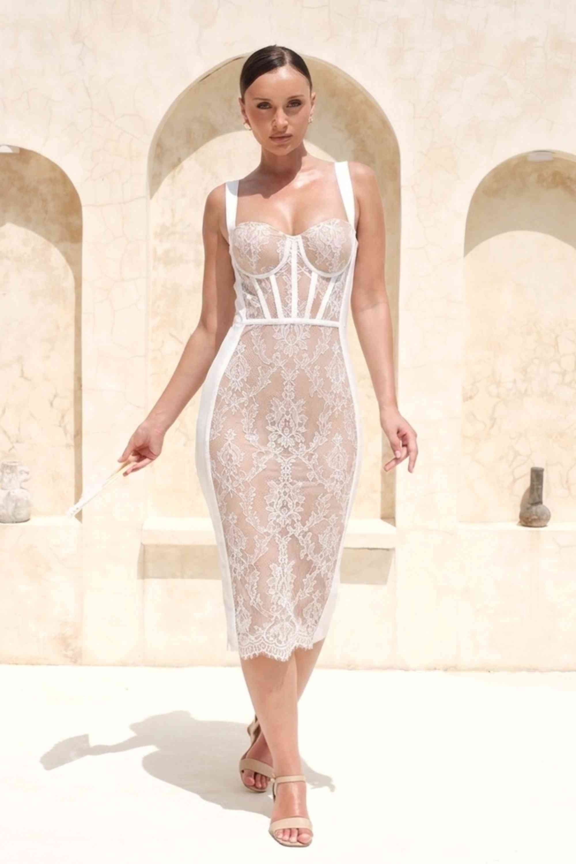 Woman wearing a figure flattering Genevieve Bodycon Lace Midi Dress - White Pearl BODYCON COLLECTION