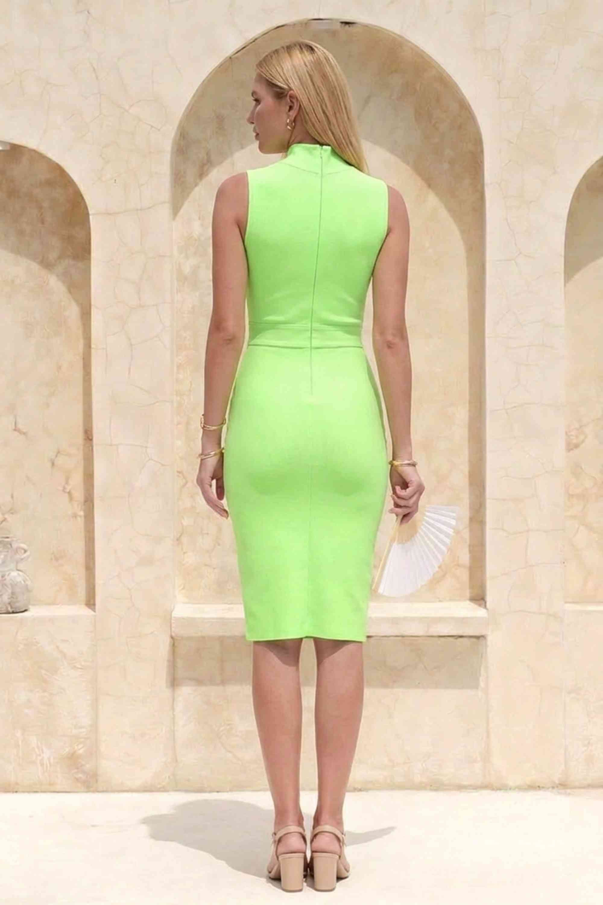 Woman wearing a figure flattering Grace Bandage Midi Dress - Neon Green Bodycon Collection
