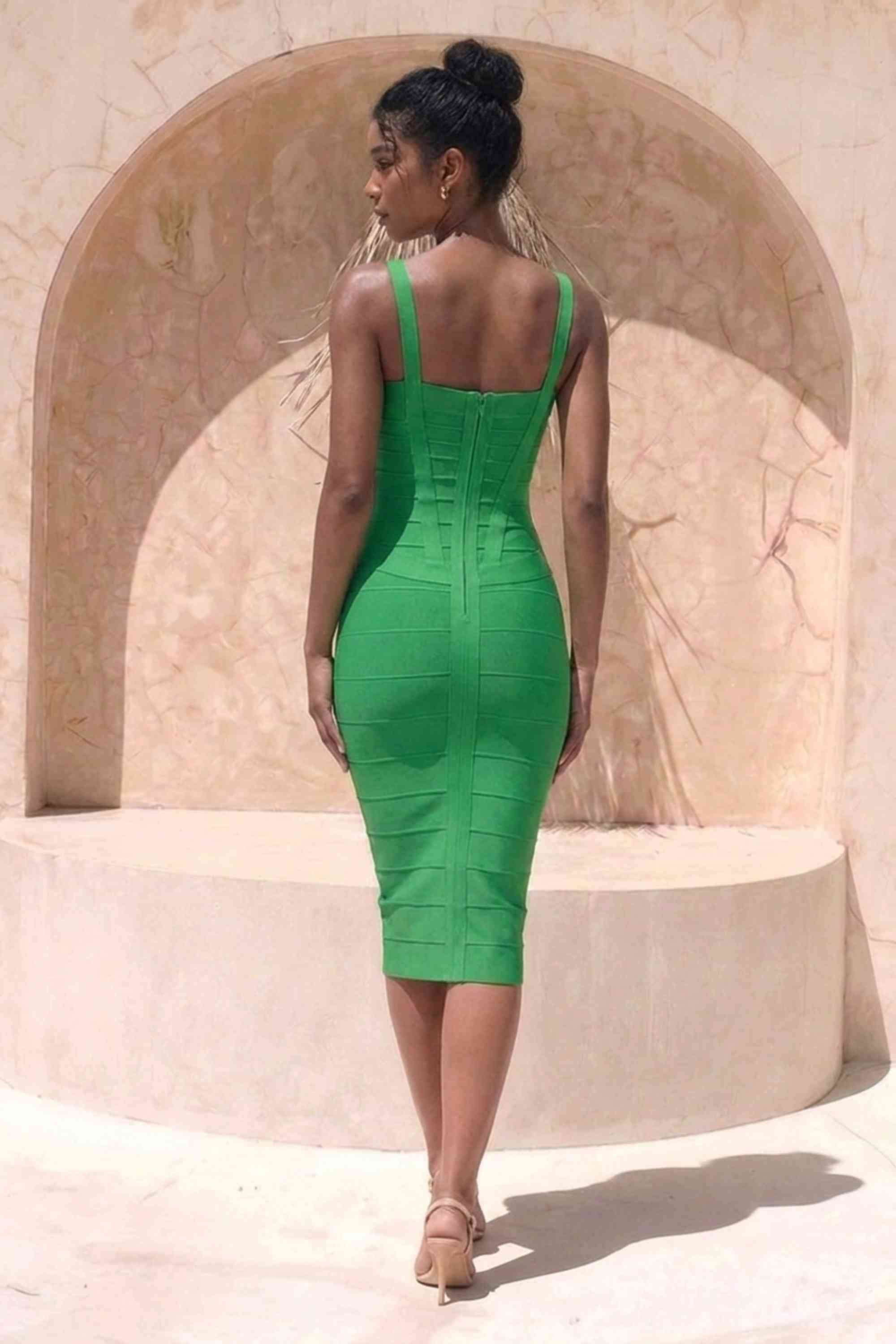 Woman wearing a figure flattering green party dress Heidi Bandage Midi Dress - Emerald Green Bodycon Collection
