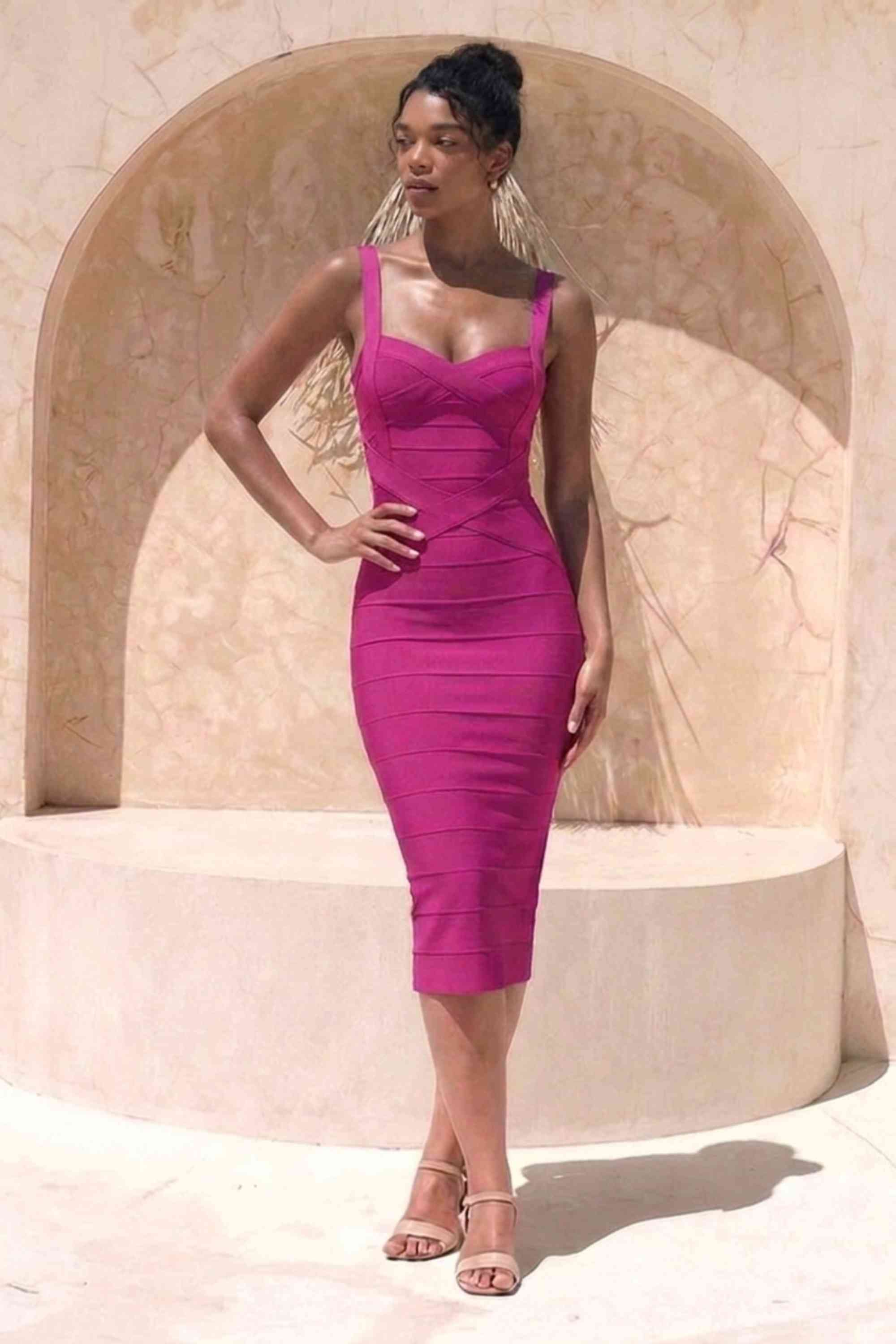 Woman wearing a figure flattering magenta pink party dress Heidi Bandage Midi Dress - Magenta Pink Bodycon Collection