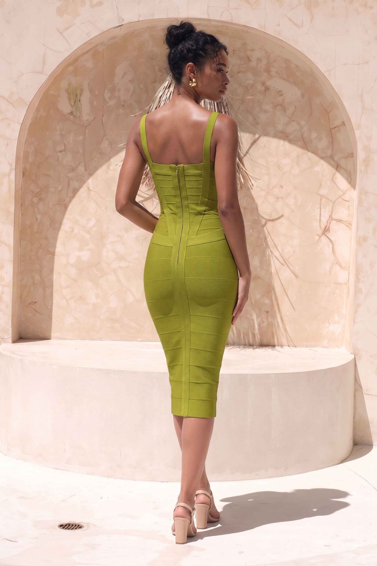Woman wearing a figure flattering Heidi Bandage Midi Dress - Olive Green Bodycon Collection