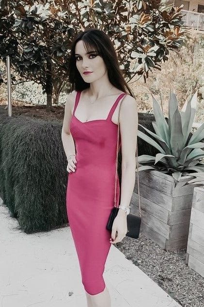 Woman wearing a figure flattering Heidi Bandage Midi Dress - Pearl White Bodycon Collection