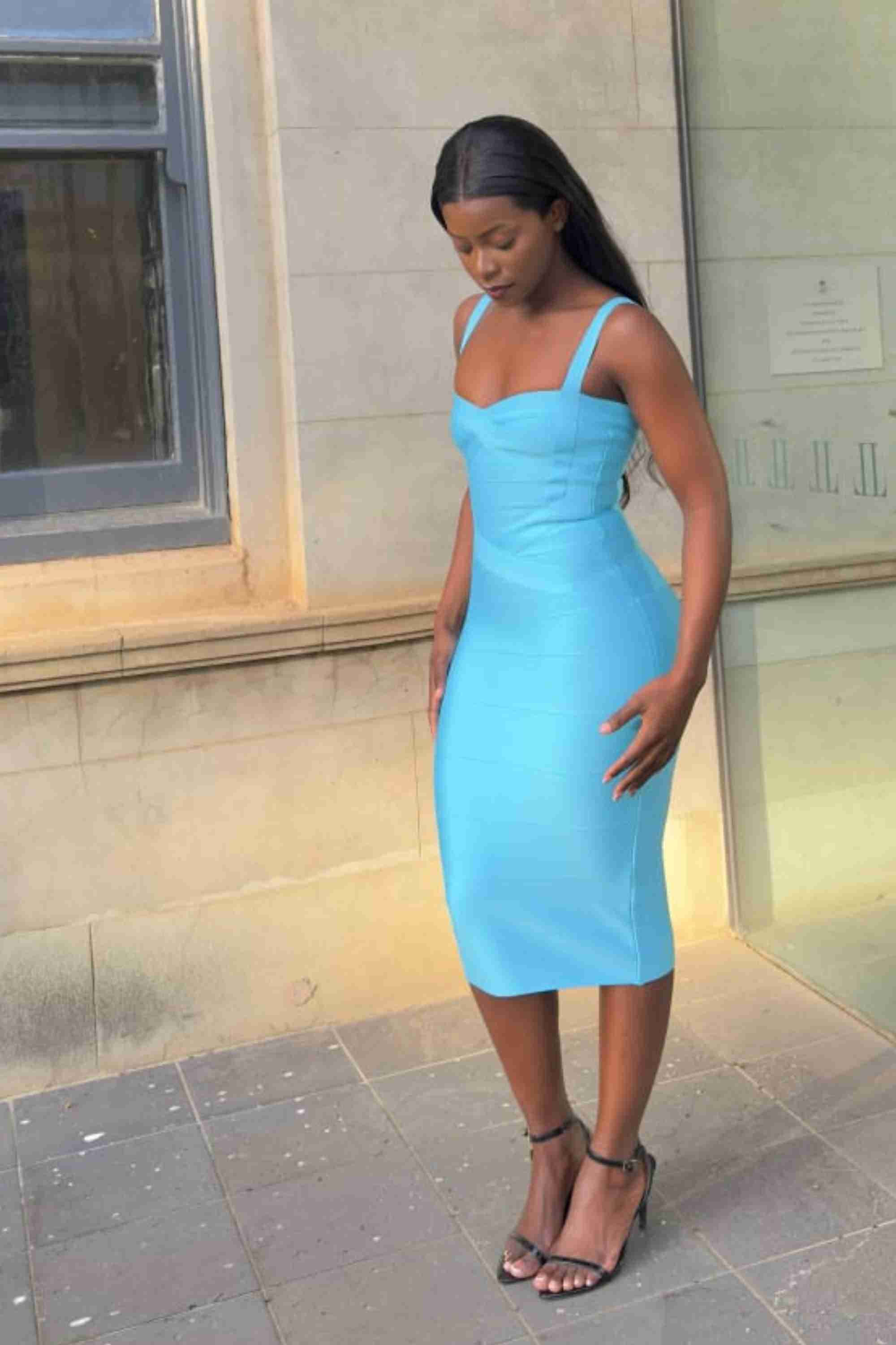 Woman wearing a figure flattering Heidi Bandage Midi Dress - Sky Blue Bodycon Collection