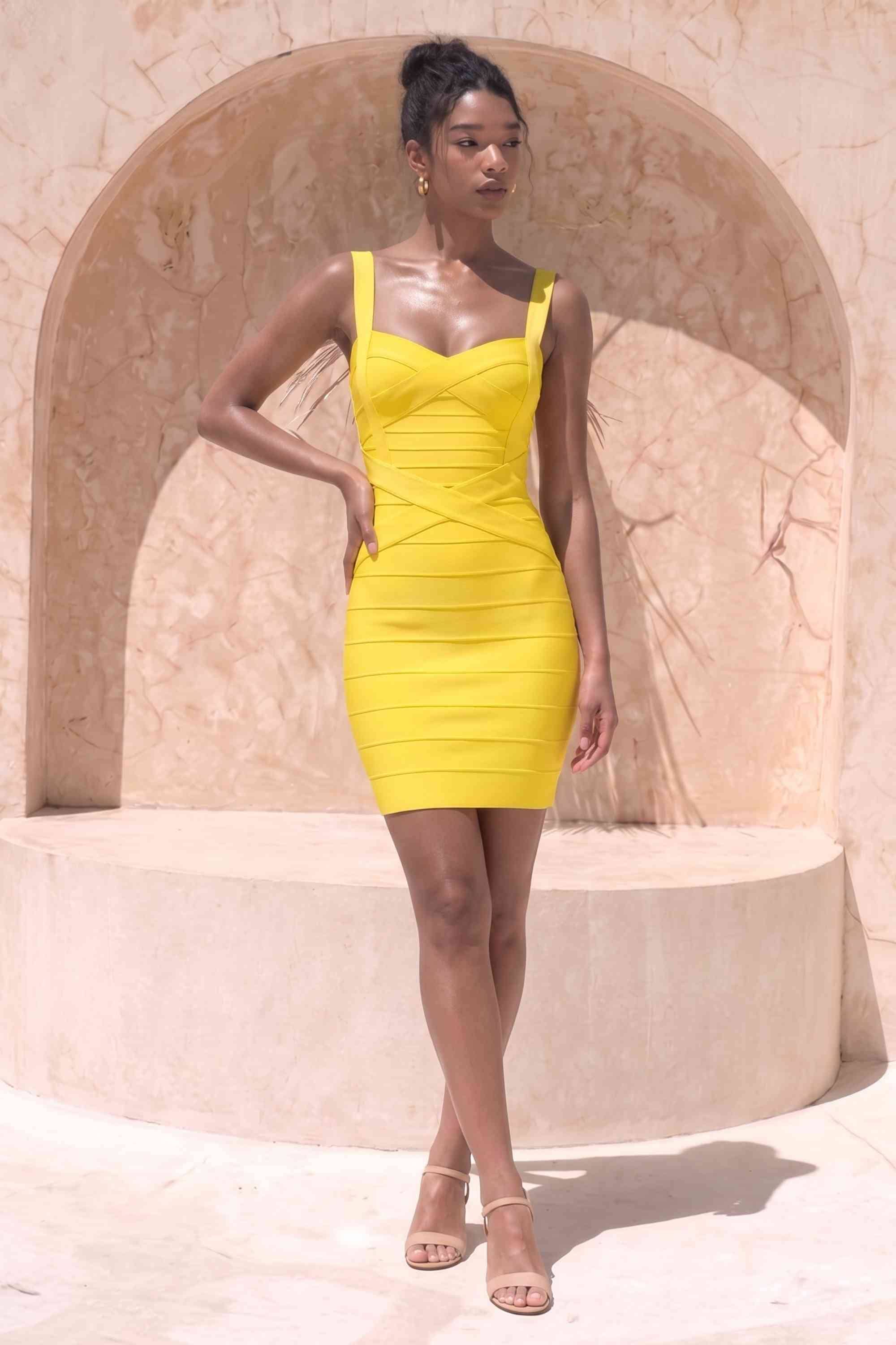 Woman wearing a figure flattering Heidi Bandage Mini Dress - Sun Yellow Bodycon Collection