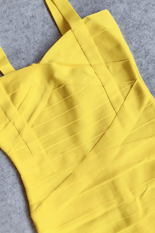Woman wearing a figure flattering Heidi Bandage Mini Dress - Sun Yellow Bodycon Collection