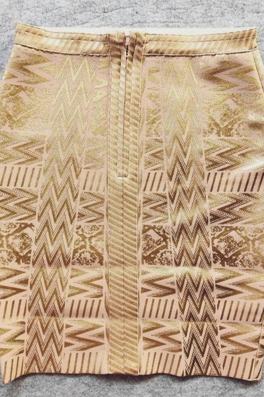 Woman wearing a figure flattering High Waist Metallic Mini Skirt - Gold BODYCON COLLECTION