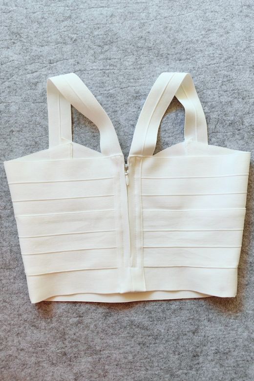 Woman wearing a figure flattering Jay Bandage Crop Top - Pearl White BODYCON COLLECTION