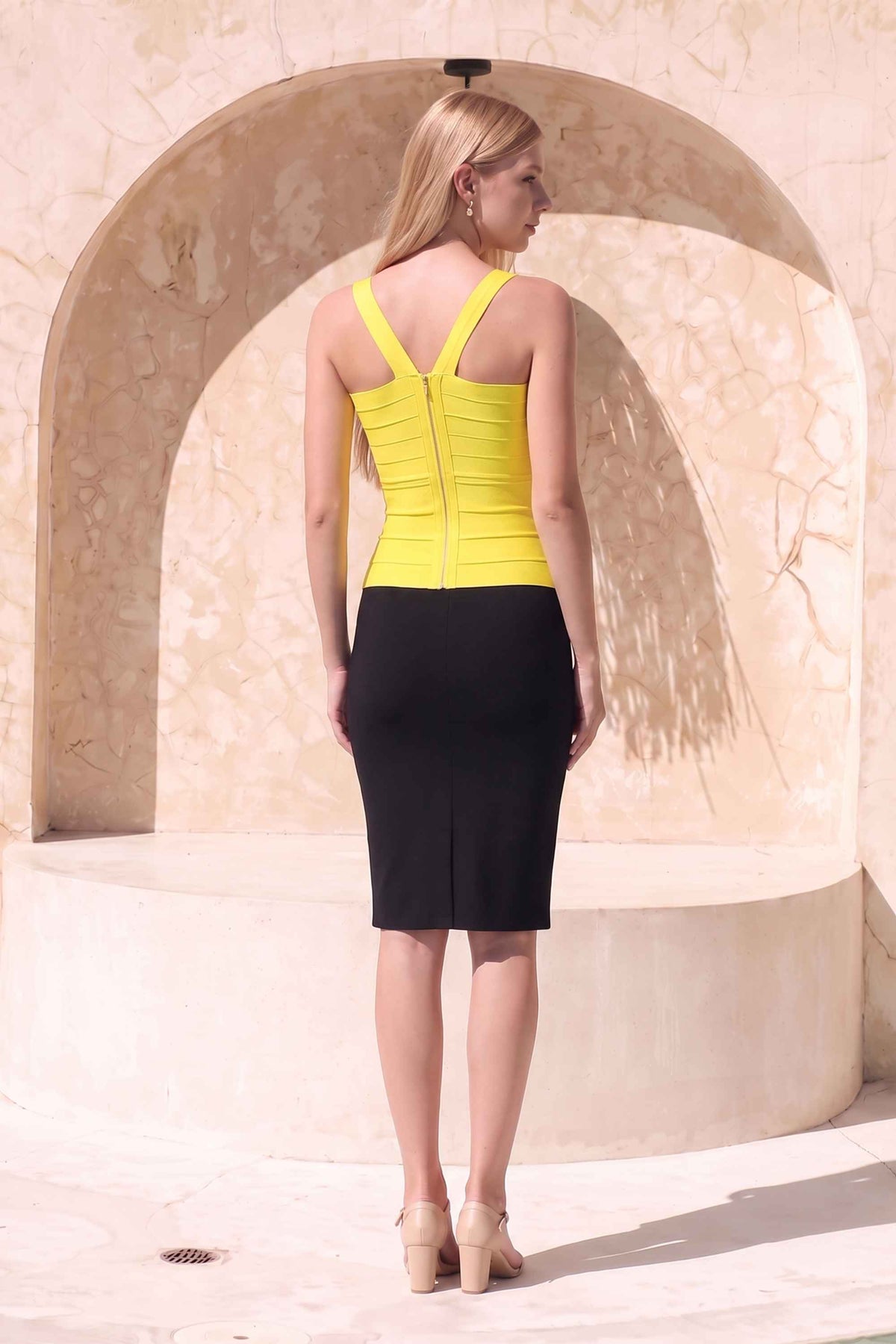 Woman wearing a figure flattering Jay Bandage Top - Sun Yellow BODYCON COLLECTION