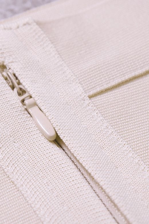 Woman wearing a figure flattering Jay High Waist Bandage Mini Skirt - Cream BODYCON COLLECTION