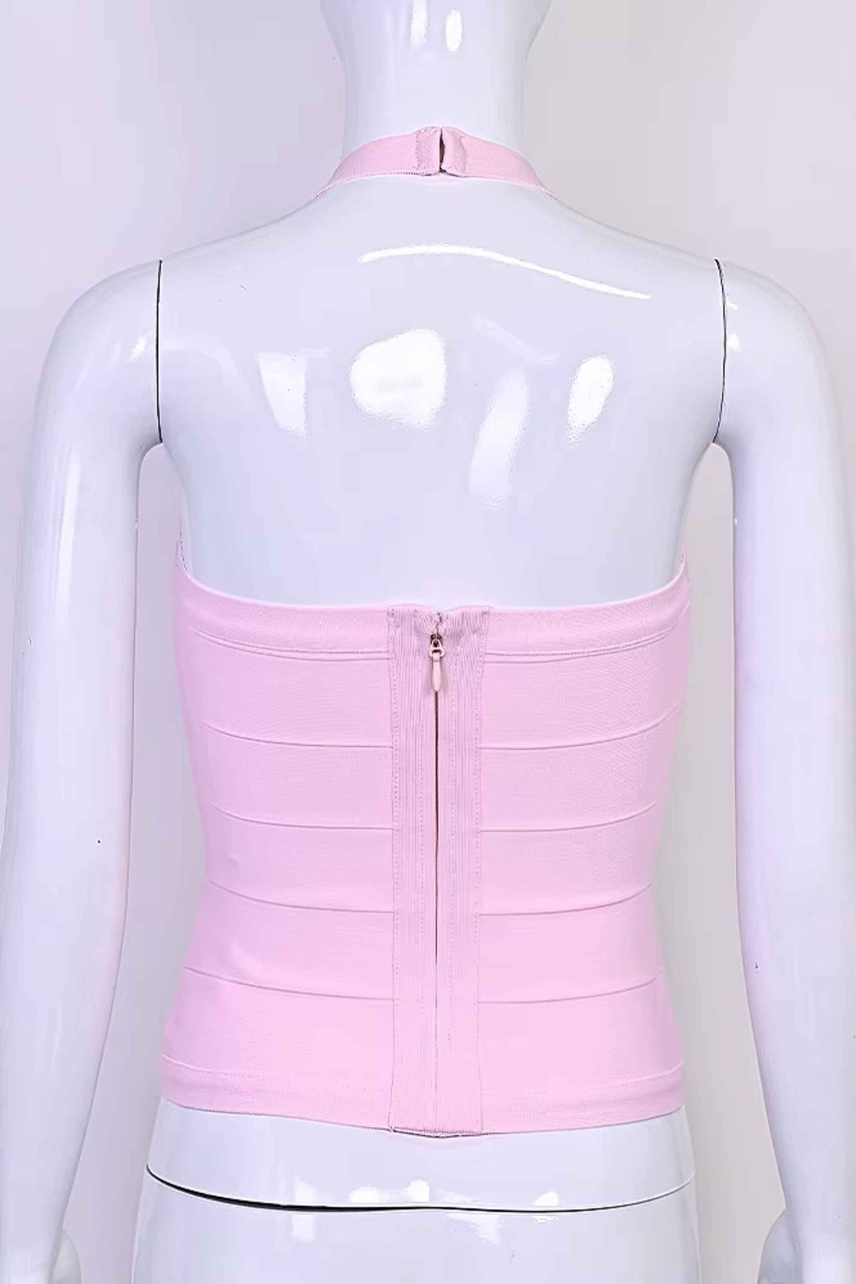 Woman wearing a figure flattering Jenna Bandage Top - Dusty Pink BODYCON COLLECTION Pty Ltd