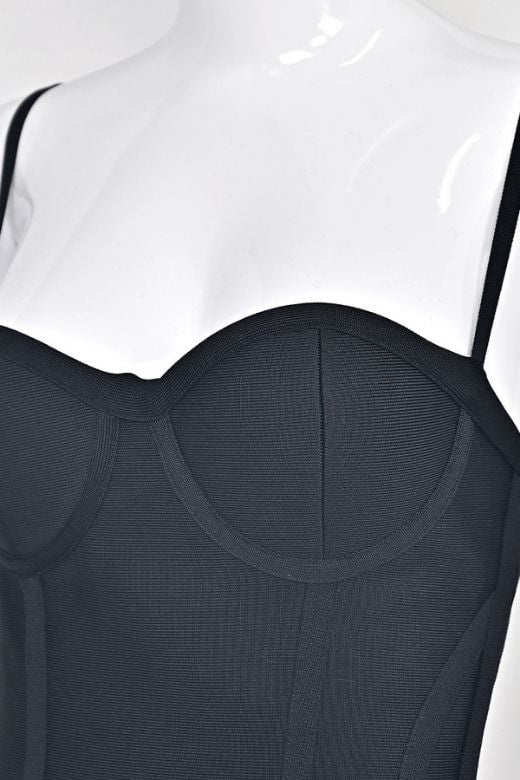 Woman wearing a figure flattering Joy Bandage Midi Dress - Classic Black Bodycon Collection