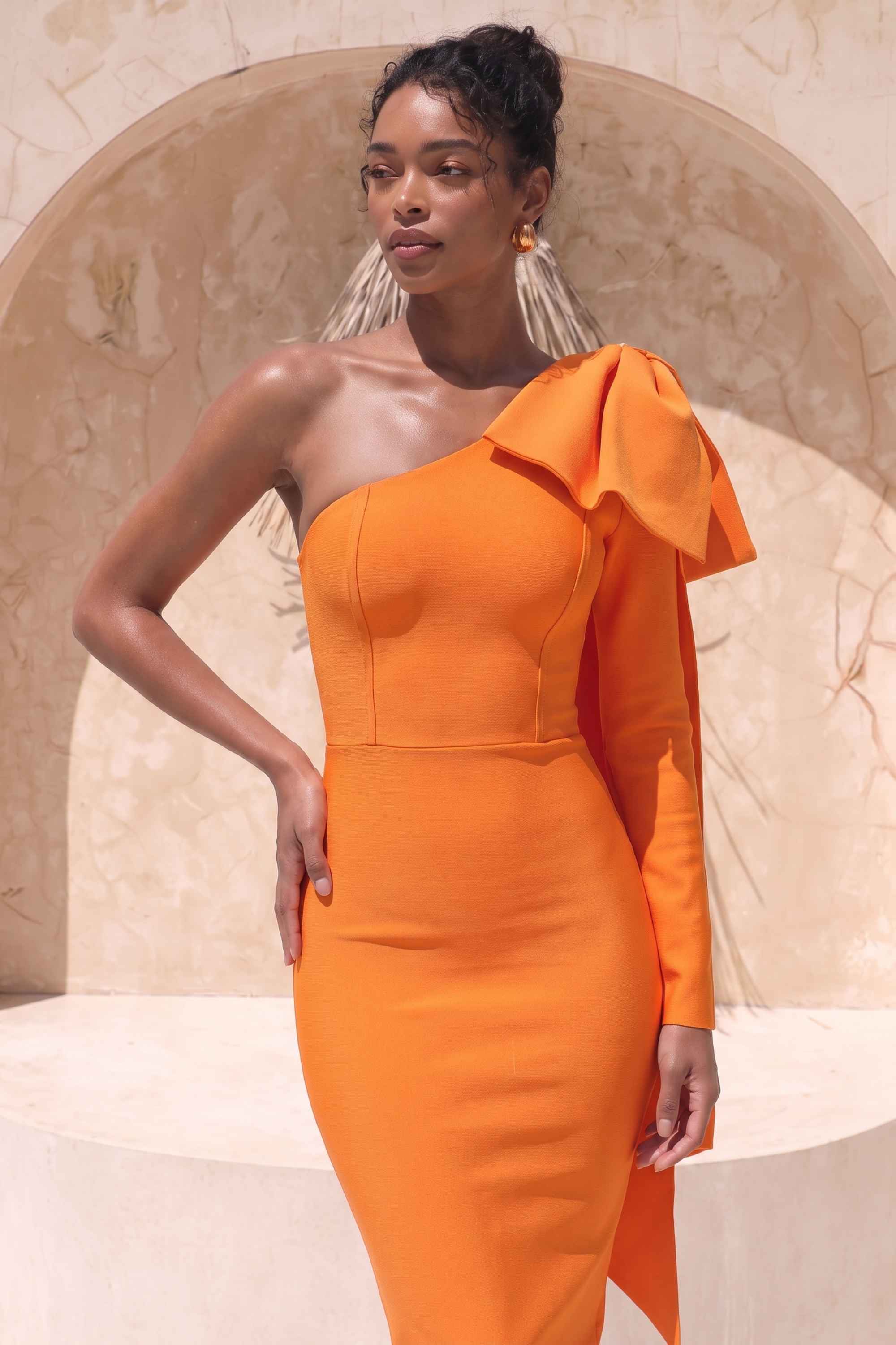 Woman wearing a figure flattering Lela Long Sleeve Bandage Midi Dress - Apricot Orange BODYCON COLLECTION