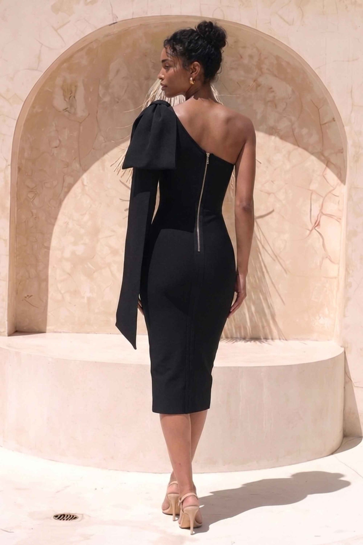 Woman wearing a figure flattering Lela Long Sleeve Bandage Midi Dress - Classic Black BODYCON COLLECTION