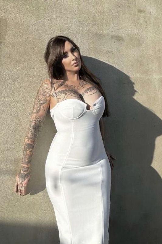 Woman wearing a figure flattering Mia Bandage Dress - Pearl White BODYCON COLLECTION