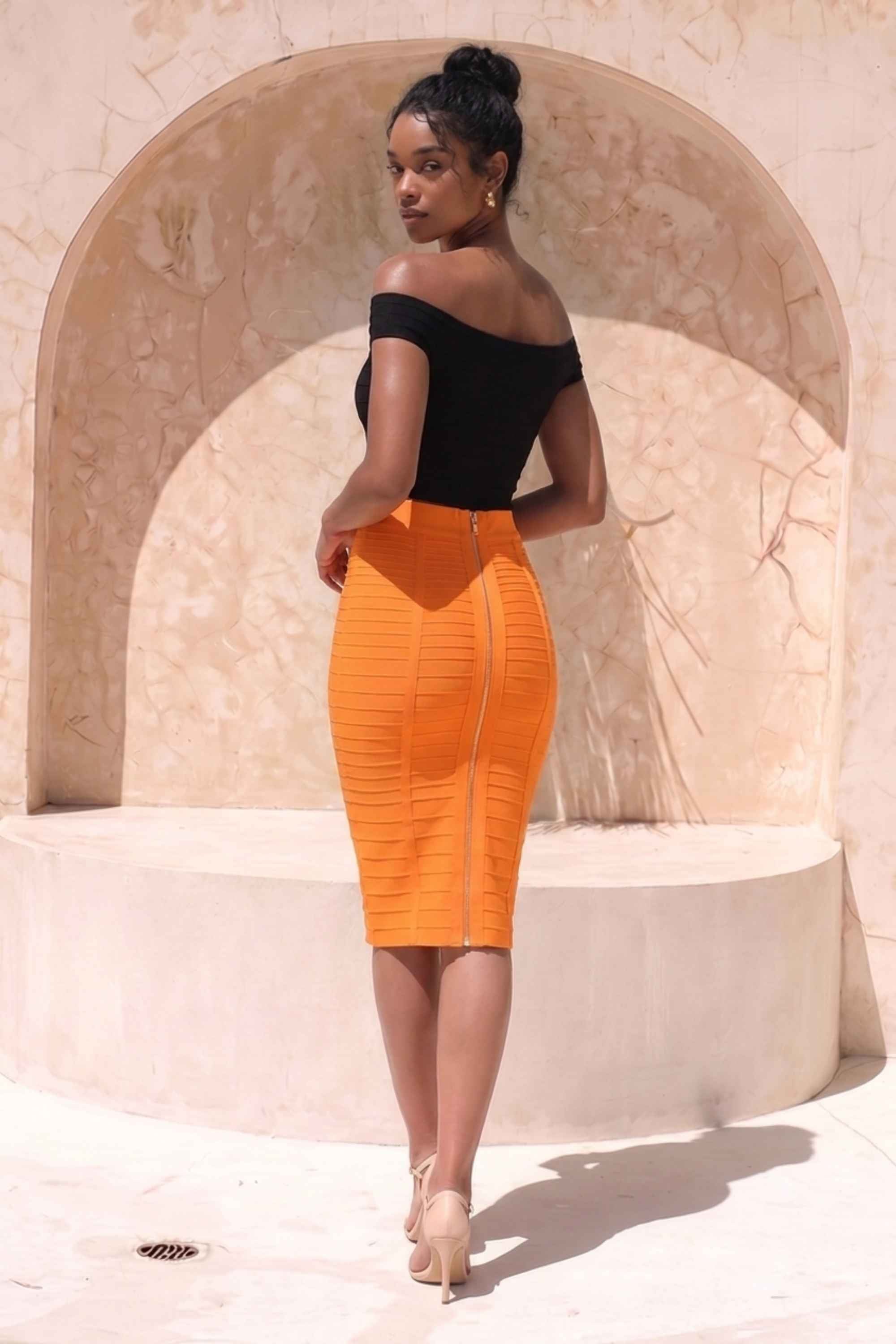 Woman wearing a figure flattering Pencil High Waist Bandage Knee Length Knitted Skirt - Apricot Orange BODYCON COLLECTION