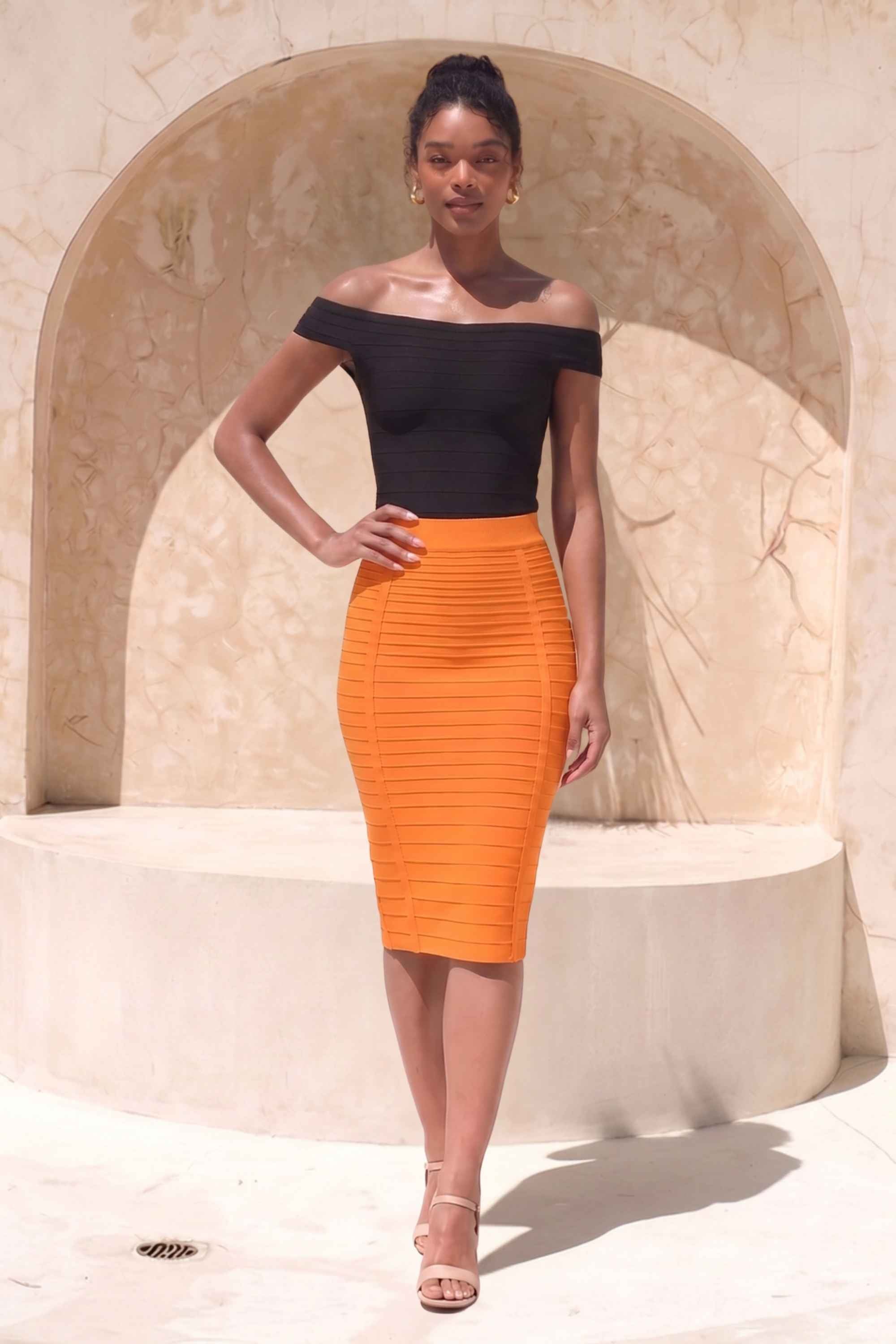 Woman wearing a figure flattering Pencil High Waist Bandage Knee Length Knitted Skirt - Apricot Orange BODYCON COLLECTION