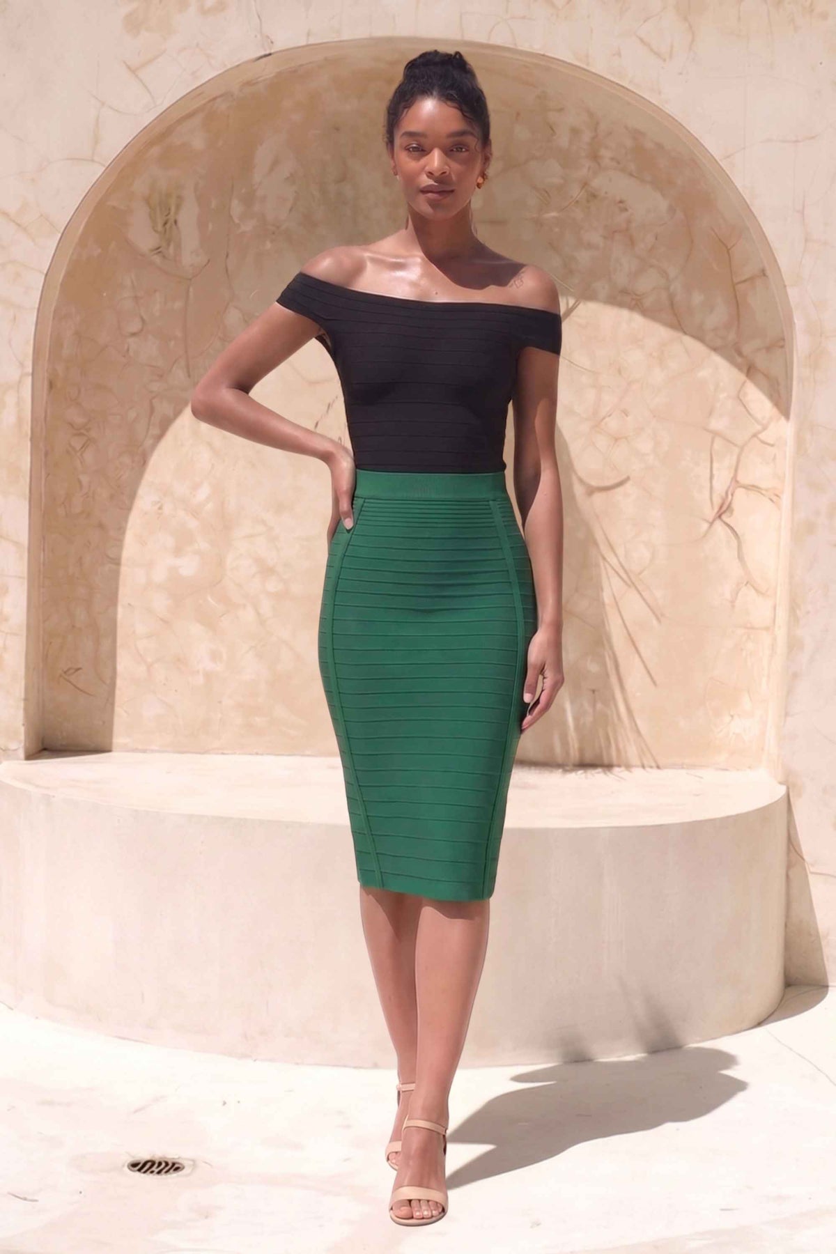 Woman wearing a figure flattering Pencil High Waist Bandage Knee Length Knitted Skirt - Emerald Green BODYCON COLLECTION