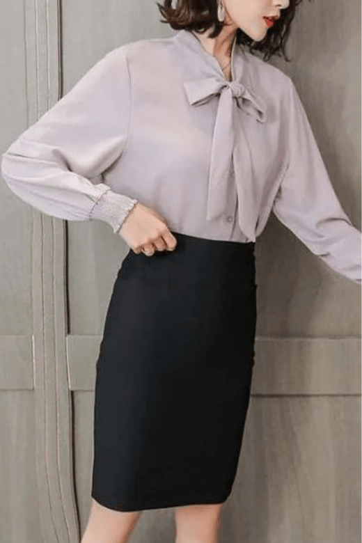 Woman wearing a figure flattering Pencil High Waist Bandage Knee Length Skirt - Navy Blue BODYCON COLLECTION