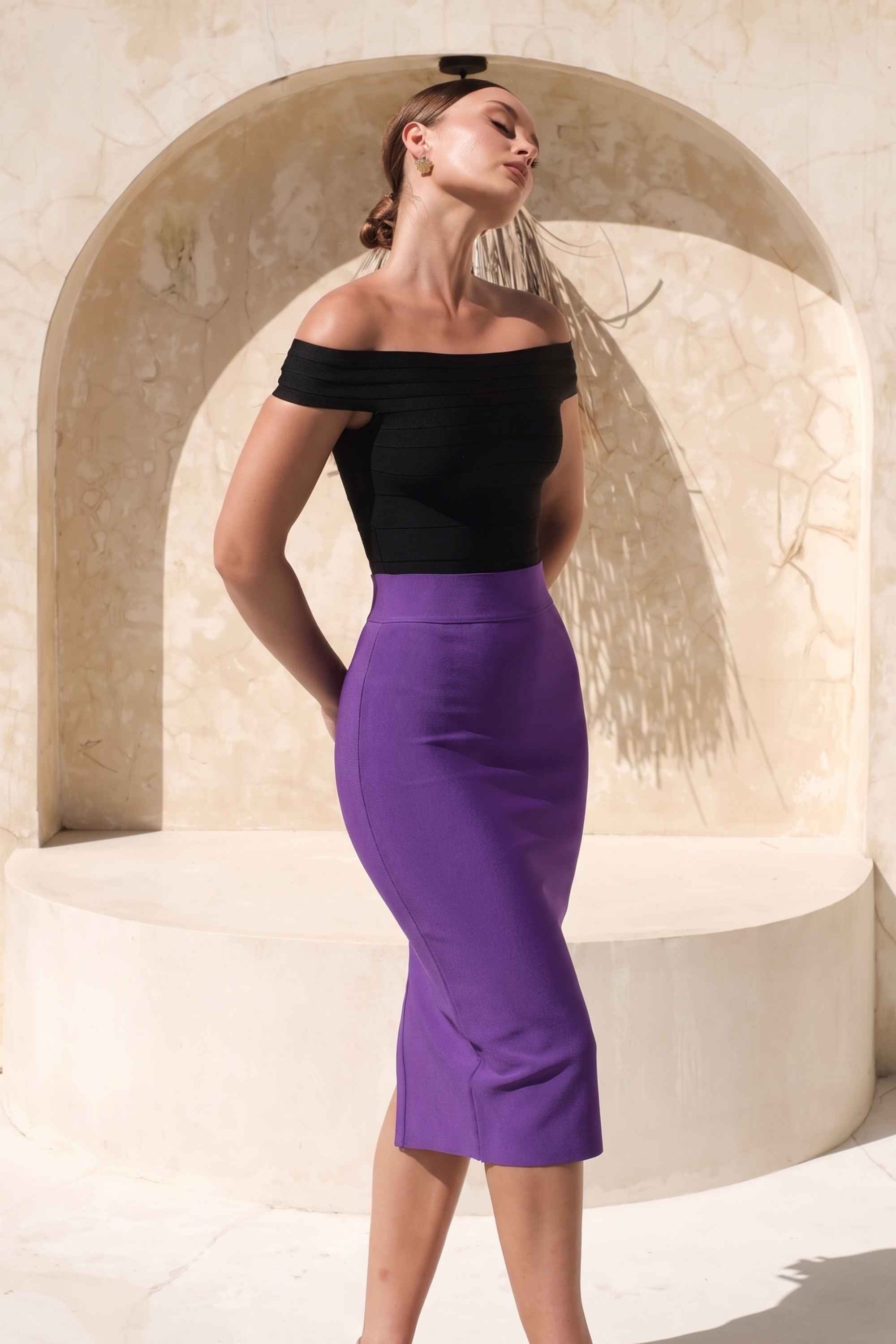 Woman wearing a figure flattering Pencil High Waist Bandage Midi Skirt - Plum Purple BODYCON COLLECTION