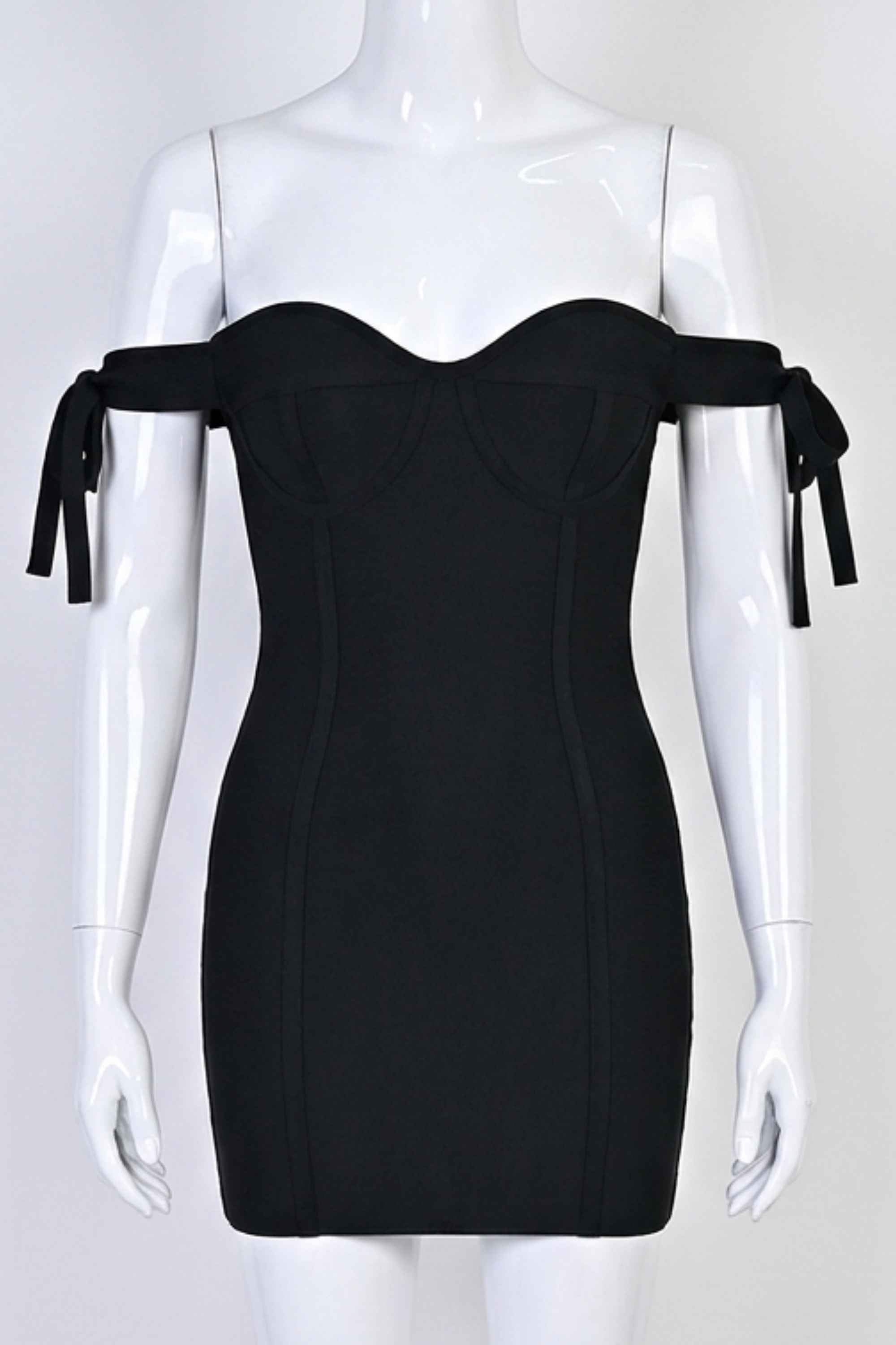 Woman wearing a figure flattering Penelope Bandage Mini Dress - Classic Black BODYCON COLLECTION