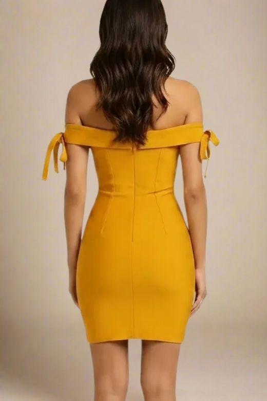 Woman wearing a figure flattering Penelope Bandage Mini Dress - Mustard Yellow BODYCON COLLECTION