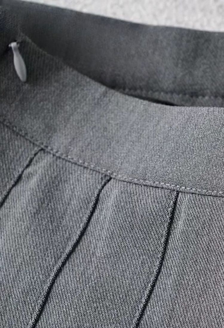 Woman wearing a figure flattering Pleated Mini Skirt - White Pearl BODYCON COLLECTION Pty Ltd