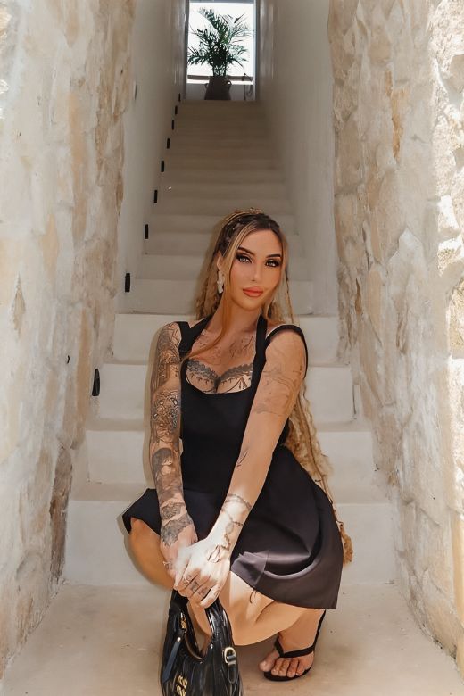 Woman wearing a figure flattering Rian Bodycon Mini Dress - Classic Black BODYCON COLLECTION