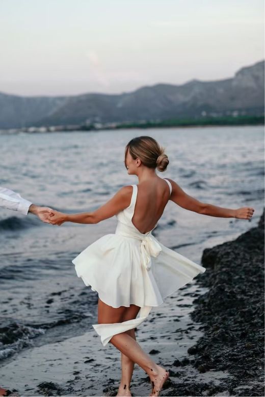 Woman wearing a figure flattering Rian Bodycon Mini Dress - Pearl White BODYCON COLLECTION