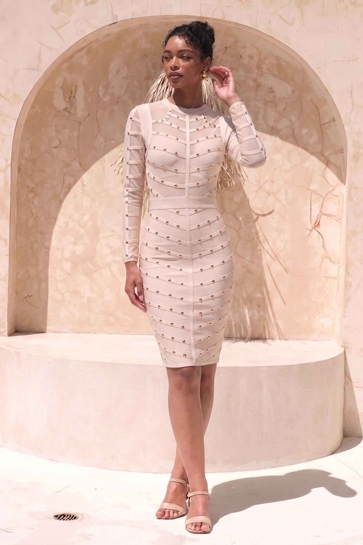 Woman wearing a figure flattering Rosa Long Sleeve Bodycon Dress - Cream BODYCON COLLECTION