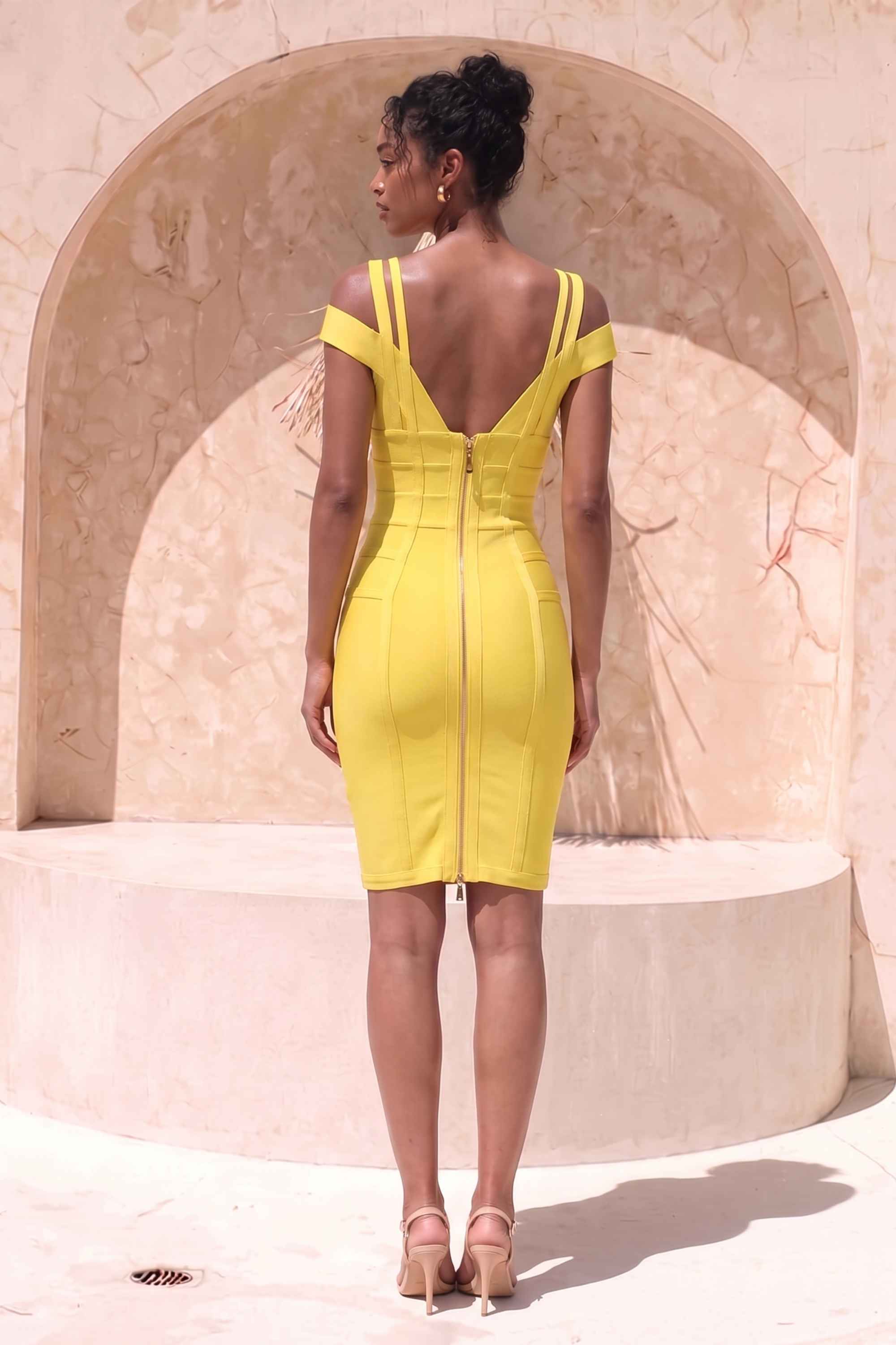 Woman wearing a figure flattering Sia Bandage Dress - Sun Yellow Bodycon Collection