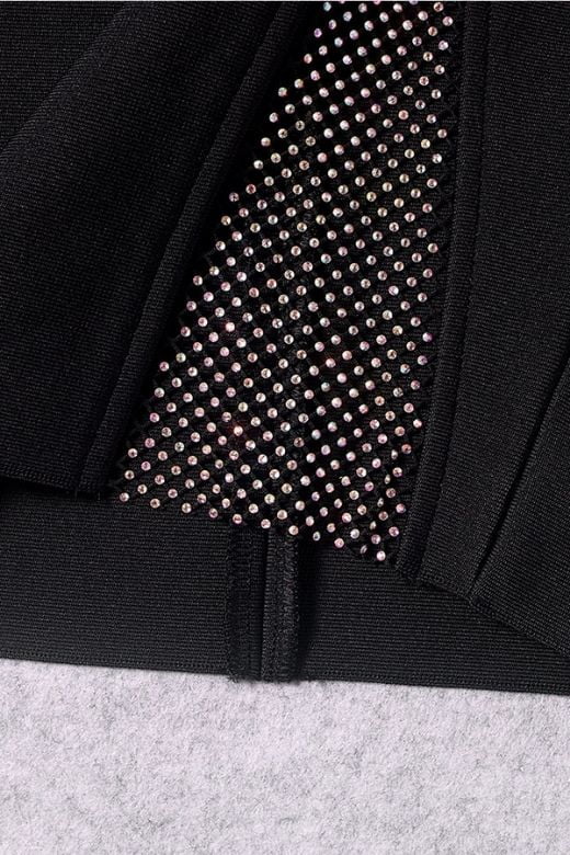 Woman wearing a figure flattering Sofie Bodycon Mini Dress - Classic Black BODYCON COLLECTION