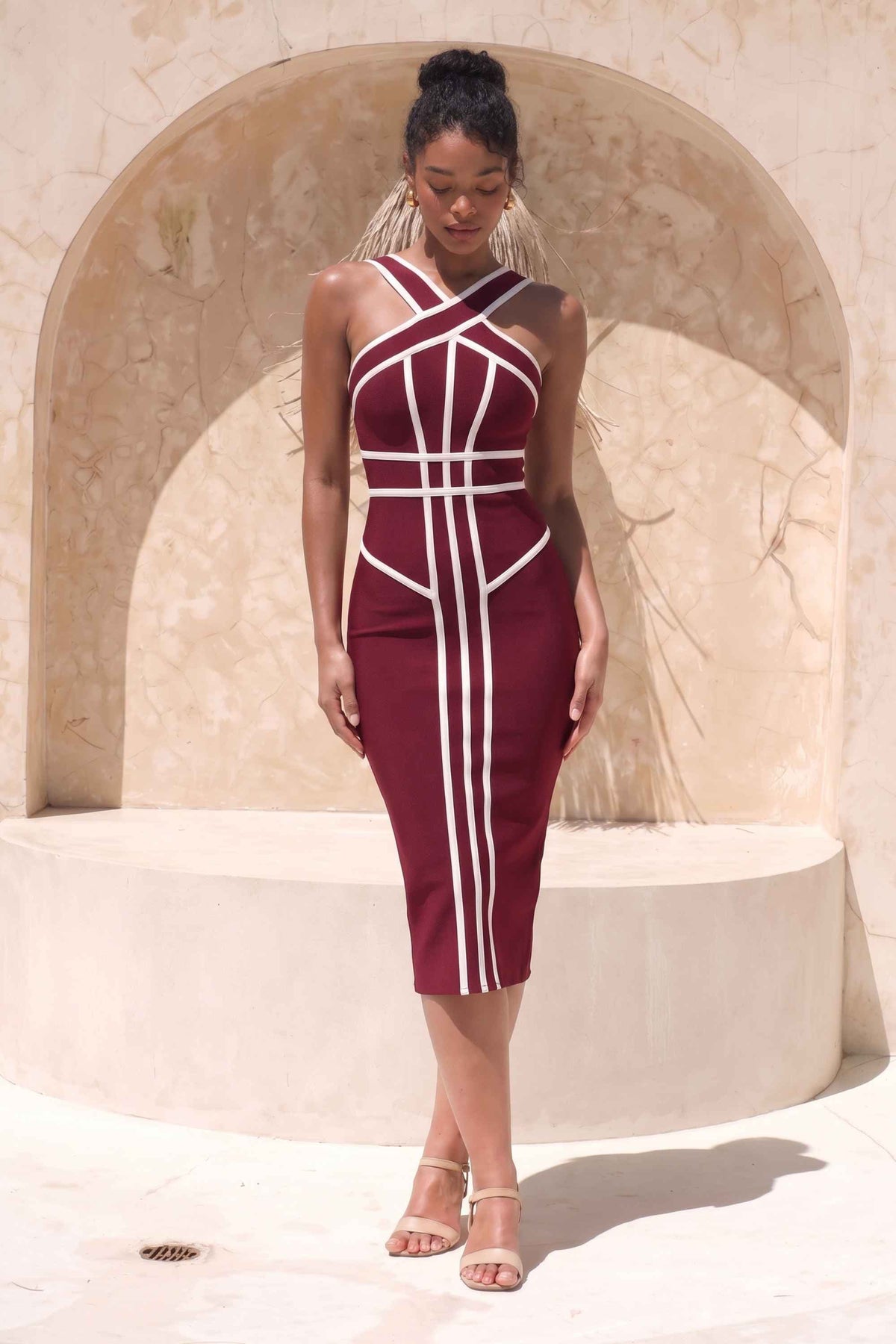 Woman wearing a figure flattering Suki Bandage Midi Dress - Red Wine BODYCON COLLECTION