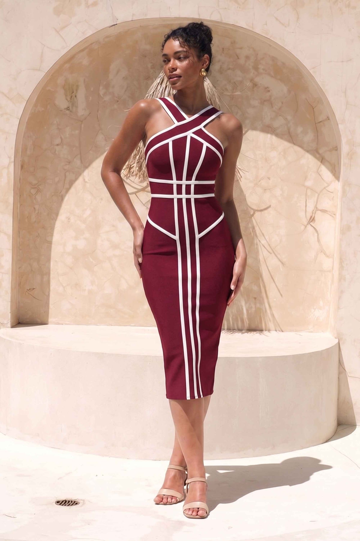 Woman wearing a figure flattering Suki Bandage Midi Dress - Red Wine BODYCON COLLECTION