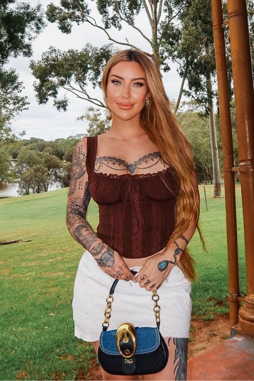 Woman wearing a figure flattering Valerie Corset Crop Top - Tan Brown BODYCON COLLECTION