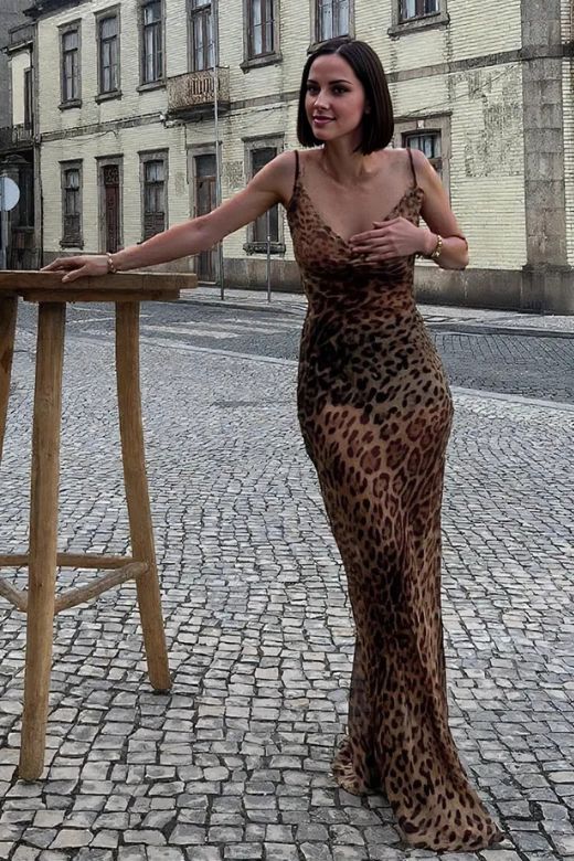 Woman wearing a figure flattering  Athena Bodycon Maxi Dress - Leopard Print Yellow BODYCON COLLECTION