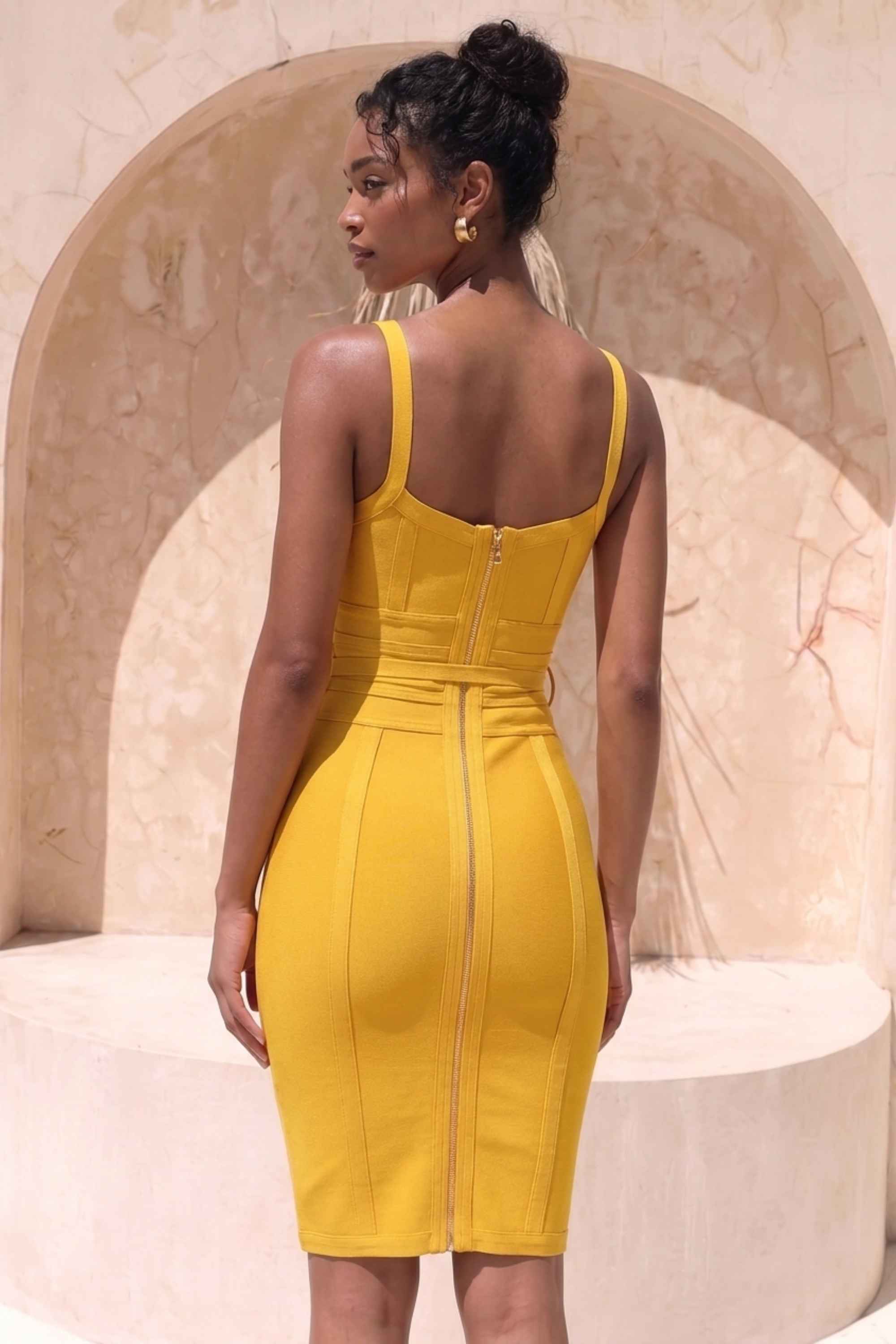 Woman wearing a figure flattering  Bek Bandage Dress - Mustard Yellow Bodycon Collection