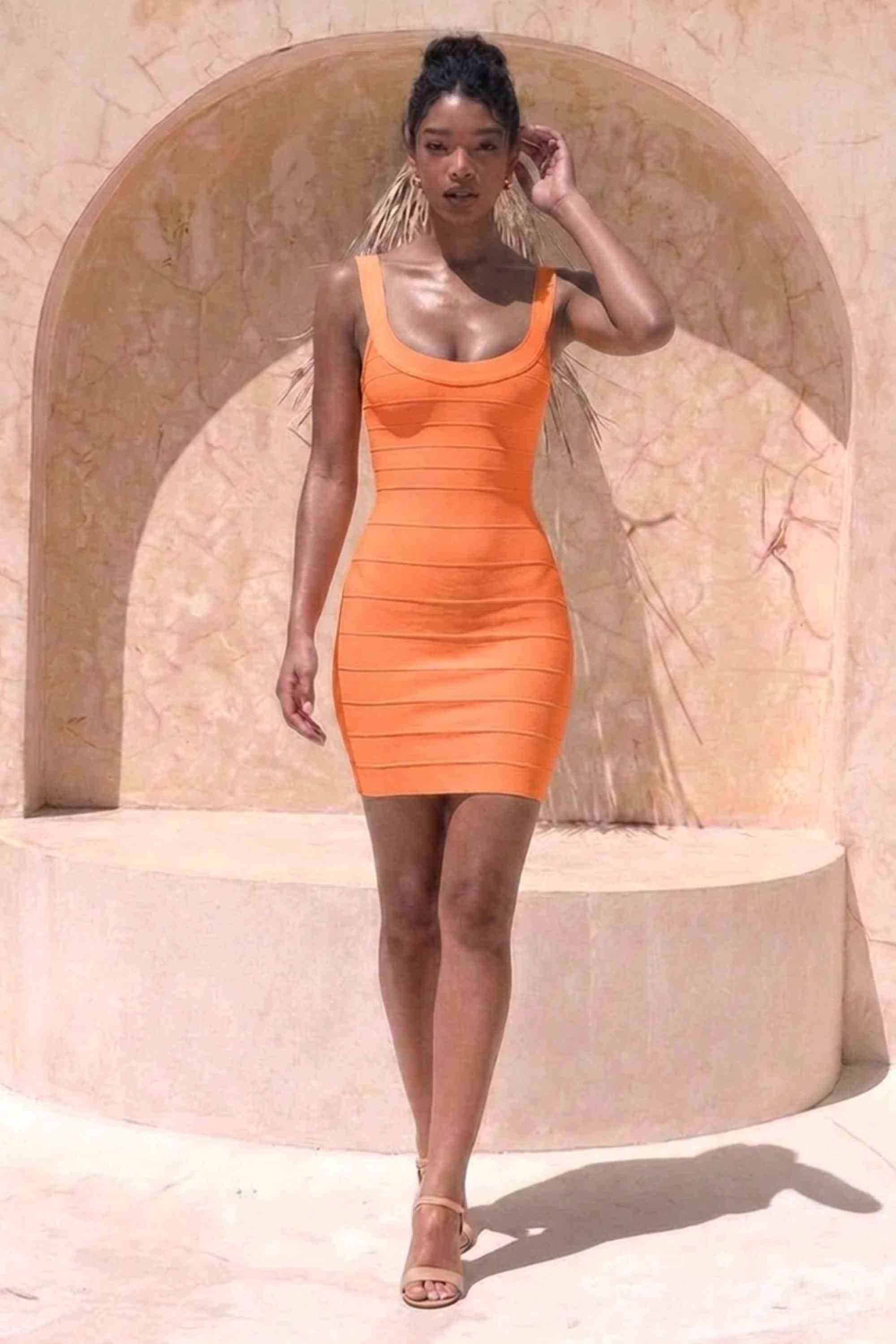 Woman wearing a figure flattering  Cindy Bandage Mini Dress - Apricot Orange BODYCON COLLECTION Pty Ltd