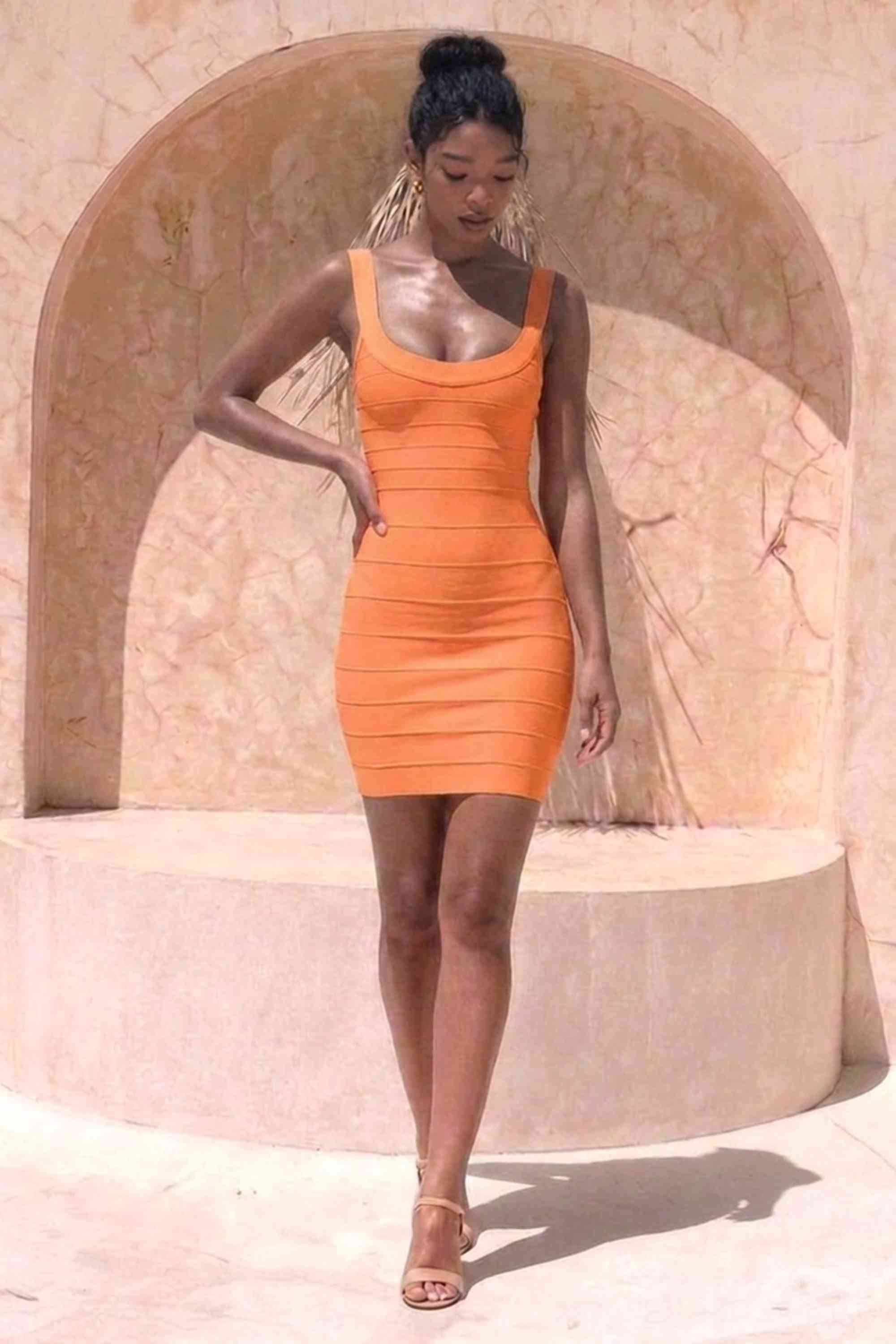Woman wearing a figure flattering  Cindy Bandage Mini Dress - Apricot Orange BODYCON COLLECTION Pty Ltd