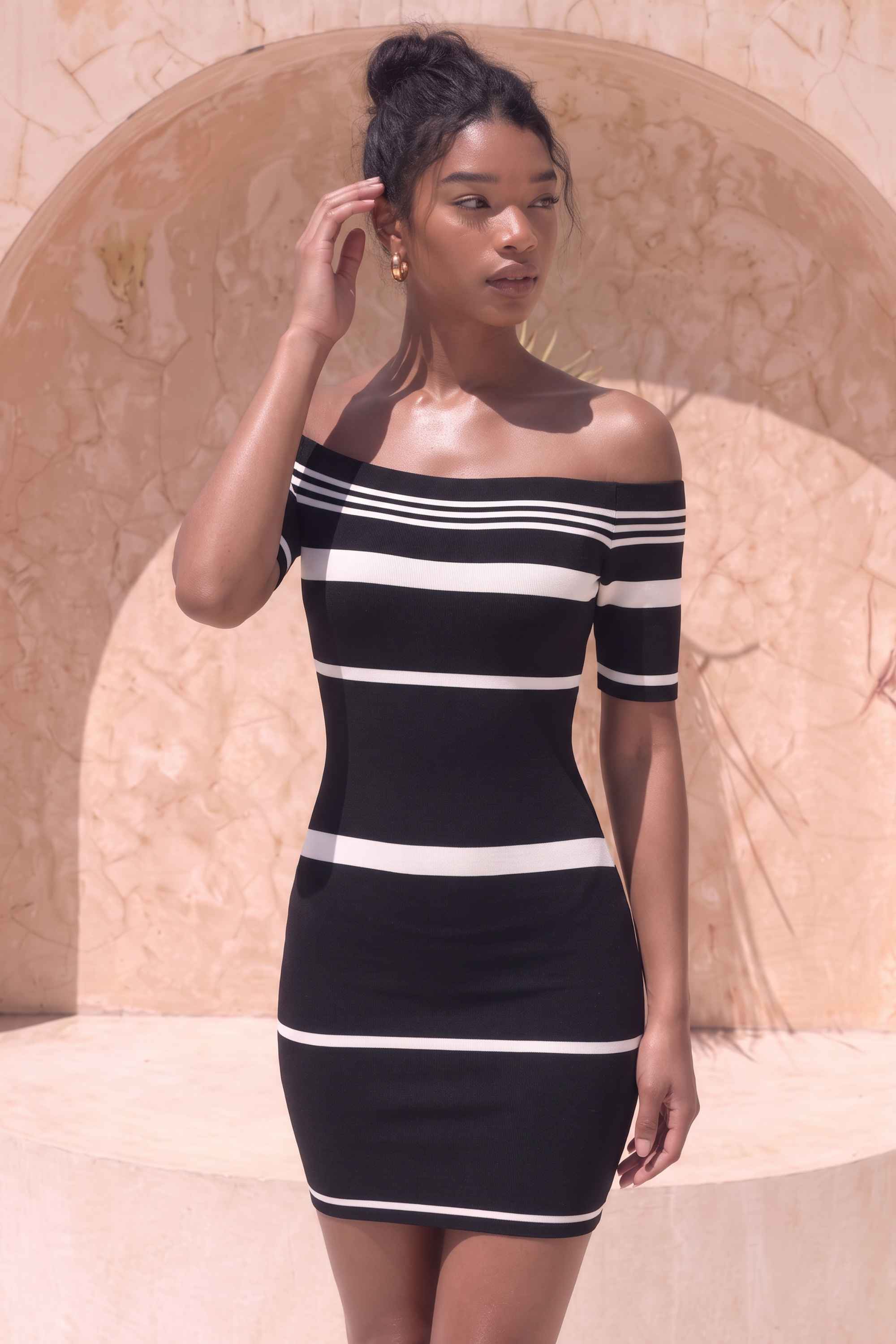 Woman wearing a figure flattering  Evelyn Bandage Mini Dress - Classic Black BODYCON COLLECTION Pty Ltd